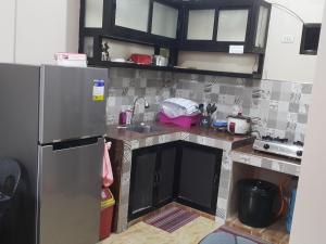 a kitchen with a stainless steel refrigerator in it at Eve's Place Transient Apartment in Tanay +7 photos