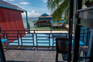 a balcony with a view of a swimming pool at Vagabonds in Kaôh Rŭng (3)