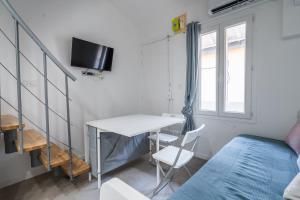 a small room with a table and a bed and a window at Bonsai Flat in Beausoleil in Beausoleil