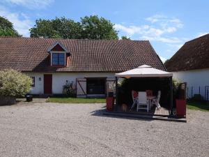 a white house with a table and an umbrella at Villa Naffen1 in Malmö