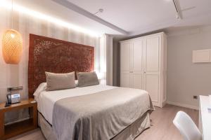 Posteľ alebo postele v izbe v ubytovaní Serennia Fira Gran Via Exclusive Rooms