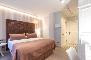 Posteľ alebo postele v izbe v ubytovaní Serennia Fira Gran Via Exclusive Rooms
