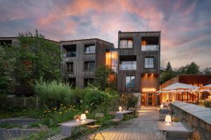 a building with tables and chairs in front of it at Eden Hotel in Bormio