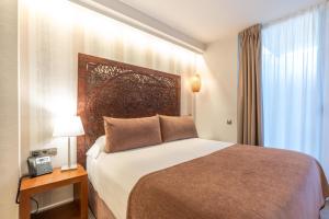 Posteľ alebo postele v izbe v ubytovaní Serennia Fira Gran Via Exclusive Rooms