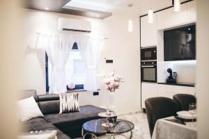 una sala de estar con un sofá y una mesa en Luxury Apartment & Rooms, en Ljubuški