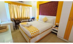 a bedroom with a large bed in a room at FabHotel Prime Stalin Pleasant Park in Chennai