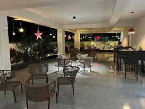 a lobby with chairs and tables and a bar at The Embassy Suites in Hyderabad