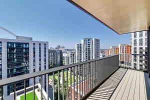 a balcony with a view of the city at Botanical-inspired apartments at Repton Gardens right in the heart of Wembley Park in London