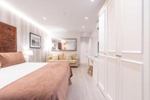 Posteľ alebo postele v izbe v ubytovaní Serennia Fira Gran Via Exclusive Rooms