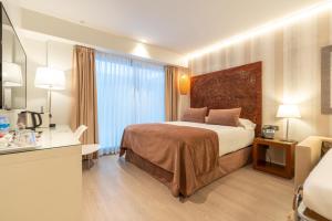 Posteľ alebo postele v izbe v ubytovaní Serennia Fira Gran Via Exclusive Rooms
