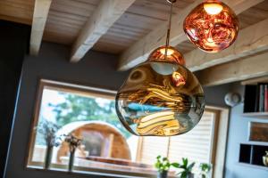 a glass ball is hanging from a ceiling at Chalet Béla Vya 5 étoiles luxe Ski & Spa in Bourg-Saint-Maurice