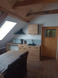 a kitchen with a wooden table and a sink at Haus Zurrik in Rennweg