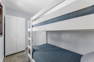 a bedroom with a bunk bed with a ladder at Casa Aldea in Puerto del Carmen
