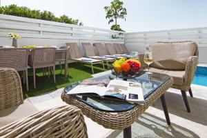 a table with a bowl of flowers on a patio at Villa Dina in Protaras