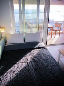 a bedroom with a bed with a view of the ocean at cloud9-skg in Thessaloniki
