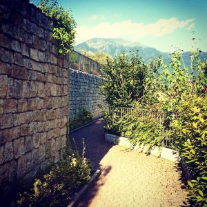 a brick wall with a pathway next to a wall at Dream of the Lake - Garda Village in Riva del Garda