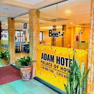 a restaurant with a yellow sign in the window at HOTEL ADAM FALIQ in Brinchang