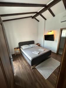 a bedroom with a bed and a television in it at Villa Aura in Orebić