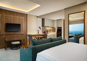 a hotel room with a bed and a kitchen at Trembesi Hotel in Serpong