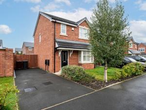 a brick house with a car parked in a driveway at Pass the Keys Modern and Cozy Kirkby Retreat Parking Sleeps 5 in Knowsley