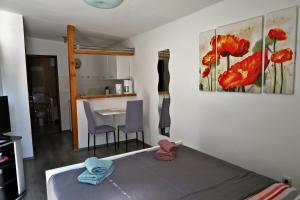a bedroom with a bed and a table and a kitchen at JASNA house with apartment in Umag
