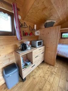 a kitchen in a tiny house with a microwave at Tiny-house in Wihr-au-Val