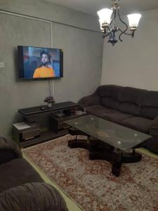 a living room with a couch and a flat screen tv at Stars paradise place in Kitengela 