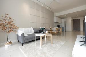 a living room with a couch and a table at Continew Residence KL CoBNB in Kuala Lumpur