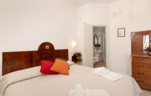 - une chambre dotée d'un grand lit avec des oreillers rouges et oranges dans l'établissement Ca'Spadolino, à Spello
