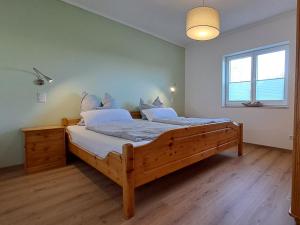 a bedroom with a large wooden bed in a room at Haus Sonnenburg in Dahlem +37 photos