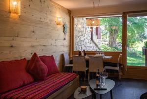 a living room with a couch and a table at Maisons de montagne Le Samovar in Val dʼIsère +23 photos