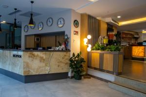 a lobby with a counter with clocks on the wall at Peramis Hotel & Spa in Antalya