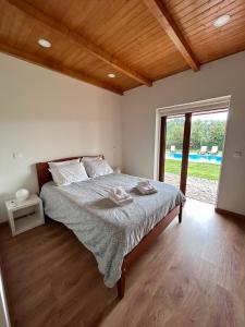 a bedroom with a bed with two towels on it at Casa de Pelicas - Celorico de Basto in Celorico de Basto