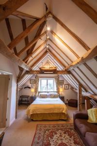 a bedroom in an attic with a bed and a window at Grafton Manor Hotel in Bromsgrove