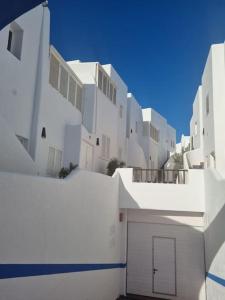 a row of white buildings with a garage at Apartamento Cerca de la Playa in Almería