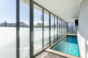a swimming pool in the middle of a building with windows at Elegant villa w dual pools in Carnaxide in Carnaxide