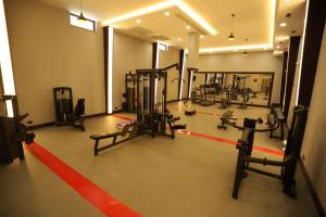a gym with several tread machines and a red line at Peramis Hotel & Spa in Antalya
