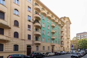 a large building with cars parked in front of it at MM Bernini Elegant & Modern Flat in Turin