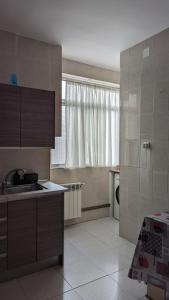 a kitchen with a sink and a counter top at Apartamento Jacobo Villar in Valladolid +2 photos