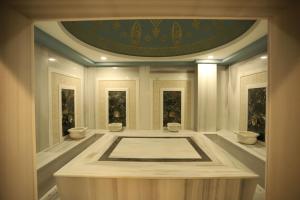 a room with a large bath tub with a ceiling at Peramis Hotel & Spa in Antalya