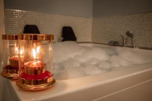 a bath tub with a candle and a candle at Peramis Hotel & Spa in Antalya