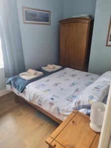 a bedroom with a bed and a wooden table at 2 Beach House in Bridlington