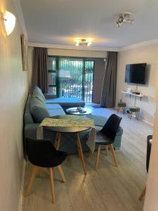 a living room with a couch and a table at 62 The Shades in Durban +3 photos