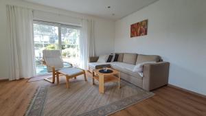 a living room with a couch and a table at Haus Sonnenburg in Dahlem