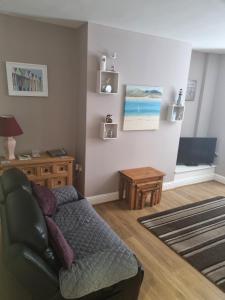 a living room with a couch and a table at 2 Beach House in Bridlington