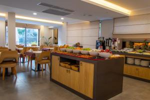 a buffet in a restaurant with bowls of fruit on a counter at Peramis Hotel & Spa in Antalya