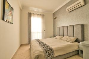 Un ou plusieurs lits dans un hébergement de l'établissement Appart Hôtel Founty Beach