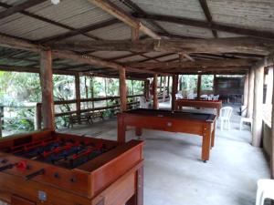 a room with two tables and a pool table at Recanto das Águas in Brejetuba