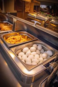 a buffet with eggs and french fries and other food at Peramis Hotel & Spa in Antalya