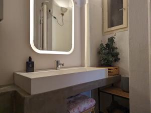 a bathroom with a white sink and a mirror at Cozy Park Apartment in Budapest